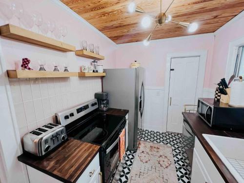 a kitchen with a stove and a refrigerator at The Historique - Charming 1BR Near Historic Downtown in Panama City