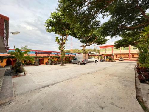 a large parking lot in front of a building at Khong Chiam Hotel in Khong Chiam
