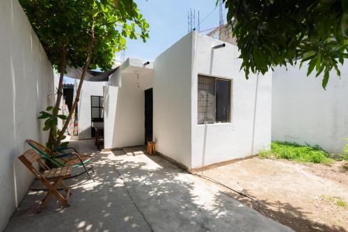 a white house with a bench next to it at Casa Blanca in Santa Cruz Huatulco