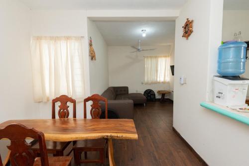 a dining table and chairs in a living room at Casa Blanca in Santa Cruz Huatulco