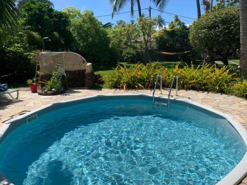 a large pool with blue water in a yard at Villa Hoama Lodge Moorea in Teavaro