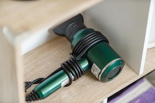 a green bottle is sitting in a drawer at Long Stay Here in Tainan