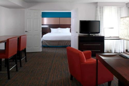 a hotel room with a bed and a television at Residence Inn by Marriott Cleveland Independence in Independence