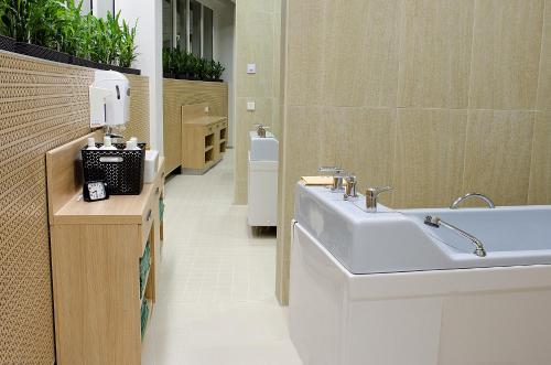 a bathroom with a sink and a bath tub at Spa Tervis in Pärnu