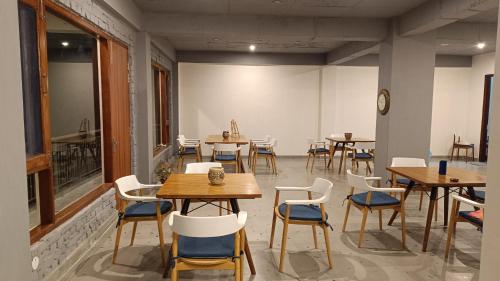 a room with tables and chairs in a restaurant at Windmill Inn in Solan