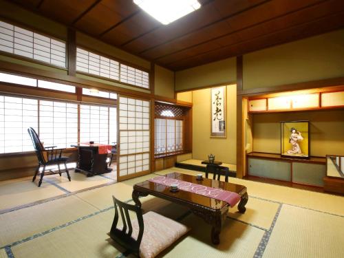 a room with a table and chairs in a room at Kisoji no Yado Iwaya in Kiso