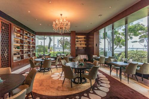 a restaurant with tables and chairs and a chandelier at Tonino Lamborghini Hotel Suzhou in Suzhou