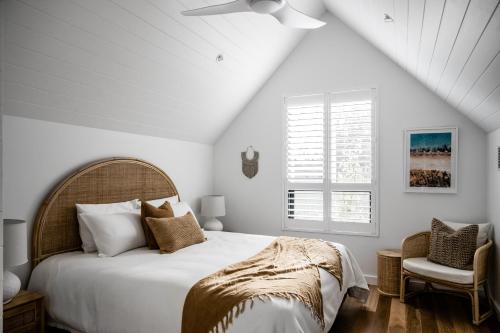 a white bedroom with a bed and a ceiling fan at Vale 194 - Newly built in McLaren Vale - 5 holiday homes with king size beds in McLaren Vale