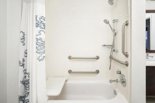 a white bathroom with a tub and a shower at Residence Inn Fort Lauderdale Plantation in Plantation