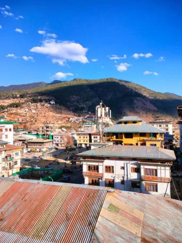 a view of a city with a mountain in the background at Nirvana Inn in Paro