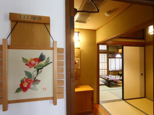 a painting on a wall next to a room at Kisoji no Yado Iwaya in Kiso