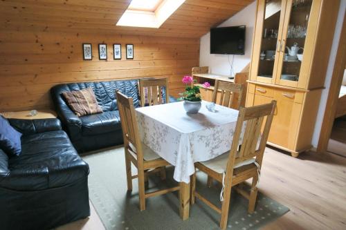 a living room with a table with chairs and a couch at Ferienwohnung Degner in Schönberg