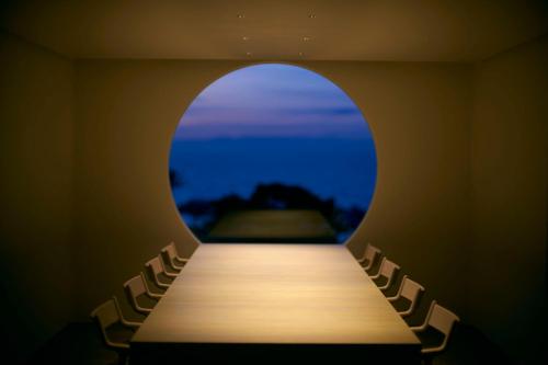 a long table with chairs in a room with a window at Tsuki to Maguro Ishigami in Yaizu