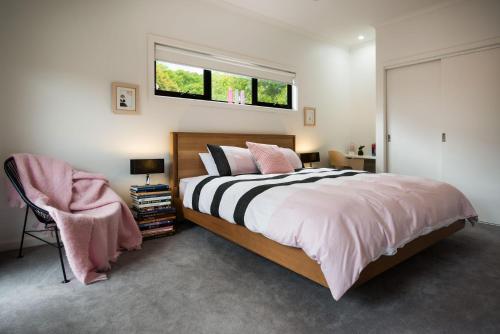 a bedroom with a large bed and a window at Wombat Hill Lodge in Daylesford
