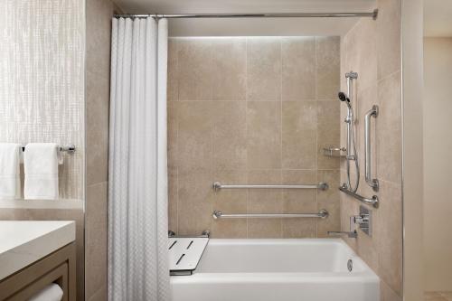 a bathroom with a white tub and a shower at Westin Georgetown, Washington D.C. in Washington