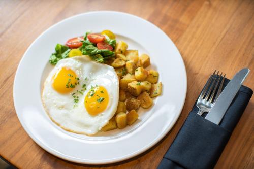 a plate of food with eggs and potatoes on a table at Westin Georgetown, Washington D.C. in Washington