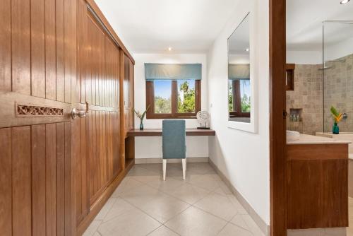 a bathroom with a wooden door and a blue chair at 4 Bedroom Pool Villa Leelavadee - close to beach in Lamai