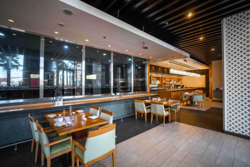 a restaurant with tables and chairs and a bar at Amwaj Rotana, Jumeirah Beach - Dubai in Dubai