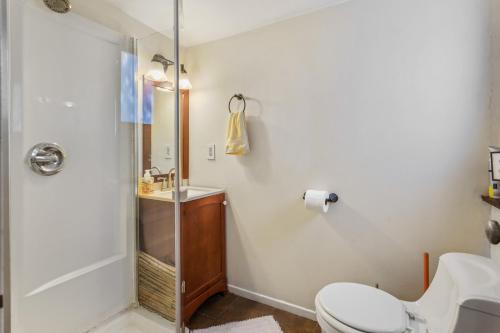 a bathroom with a shower and a toilet and a sink at Private Studio City Guest House in Los Angeles