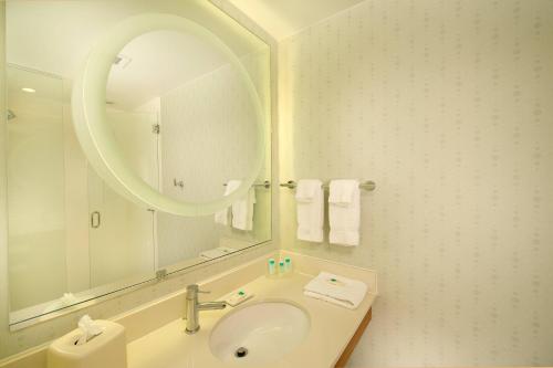 a bathroom with a sink and a mirror at SpringHill Suites Alexandria in Alexandria