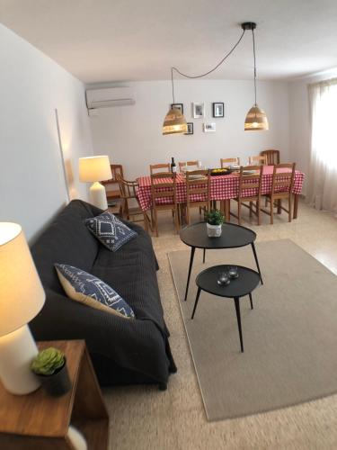 a living room with a couch and a dining room at Bienvenido a Chez Matu in Capdepera