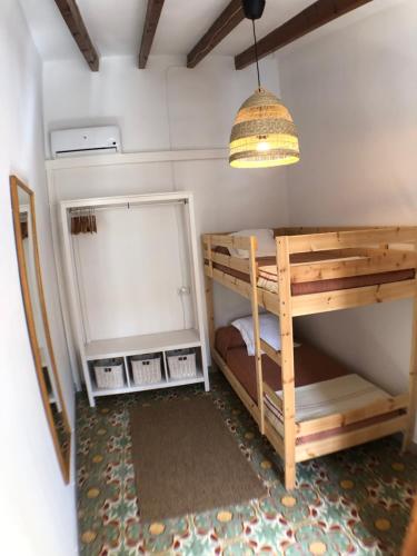 a room with two bunk beds and a light at Bienvenido a Chez Matu in Capdepera