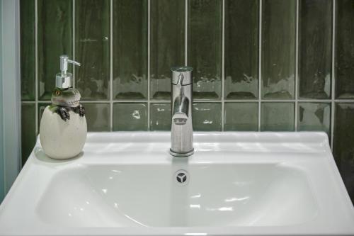 a bathroom sink with a faucet on top of it at Long Stay Here in Tainan