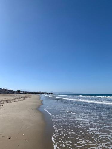 a beach with the ocean on a sunny day at Khroma Luxury Suite 2 Beach front apartment in Hersonissos