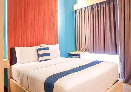 a bedroom with a large bed and a window at iCheck inn Chill Patong in Patong Beach