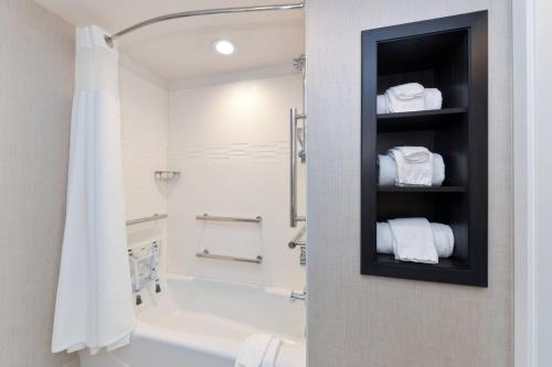 a bathroom with a shower and a white shower curtain at Residence Inn Visalia in Visalia