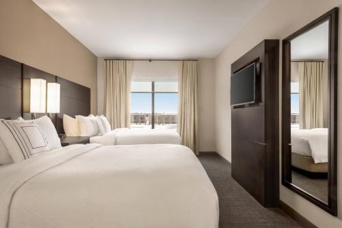 a hotel room with two beds and a television at Residence Inn by Marriott Des Moines Ankeny in Ankeny