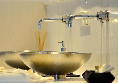 a bathroom sink with a faucet and two bowls at Caravan Park Sexten in Sesto