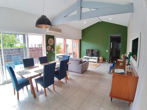 a living room with a dining table and chairs at Villa MAGDA à 30 mn mer pour vacances ou cure in Dax