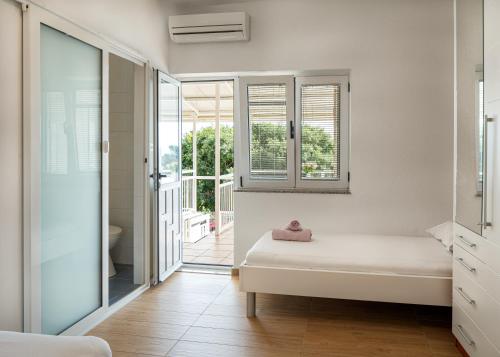 a bedroom with a bed and a sliding glass door at Apartmani Boban in Živogošće