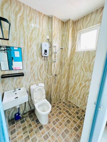 a bathroom with a toilet and a sink at Summer View Apartment + Sky pool in Kuah