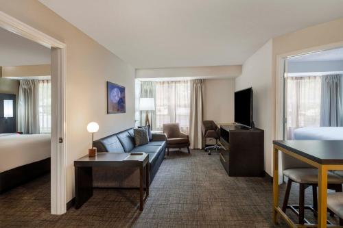 a hotel room with a couch and a bed at Residence Inn Denver Southwest/Lakewood in Lakewood
