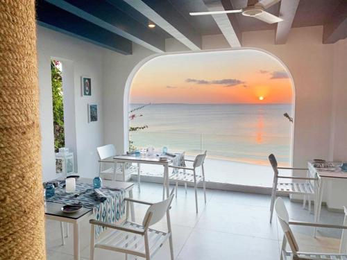 a dining room with a view of the ocean at Riu Palace Zanzibar - All Inclusive in Nungwi