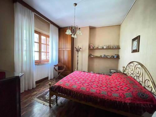 a bedroom with a red bed in a room at Casa dei nonni in Alba Adriatica