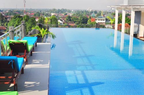 a large swimming pool on the roof of a building at Pandanaran Prawirotaman Yogyakarta in Yogyakarta