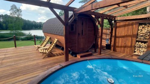 a deck with a hot tub and a gazebo at Laspopas in Guzowy Piec