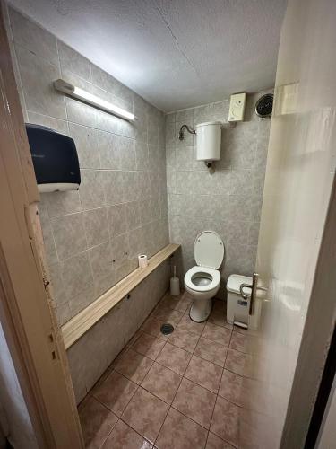 a bathroom with a toilet and a bath tub at Panorama rooms in Chios