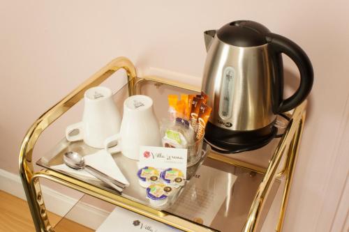 a glass table with a coffee pot on top of it at BYPILLOW Villa Lorena Adults Recommended in Málaga