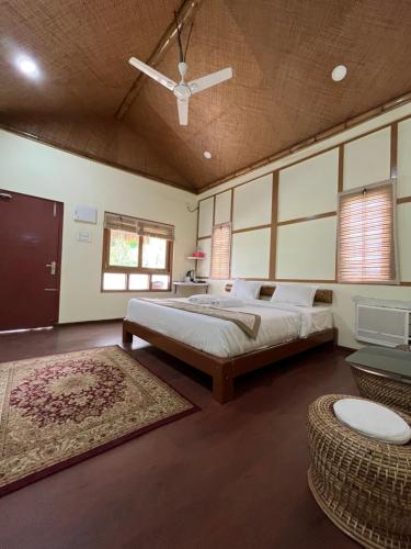 a large bedroom with a bed and a ceiling fan at Manas Jungle Retreat in Jyoti Gaon
