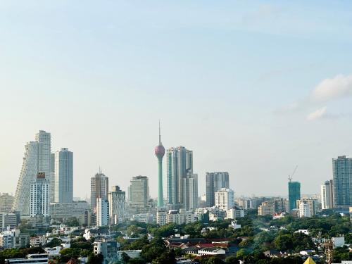 a city skyline with a lot of tall buildings at The Alfred Fern - Modern 2-Bedroom Apartment with Pool in Prime Colombo 3 in Colombo