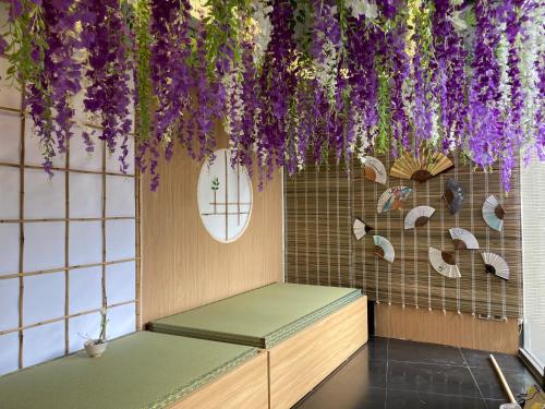 a room with purple flowers hanging from the ceiling at Kuretake Inn Kim Ma 132 in Hanoi