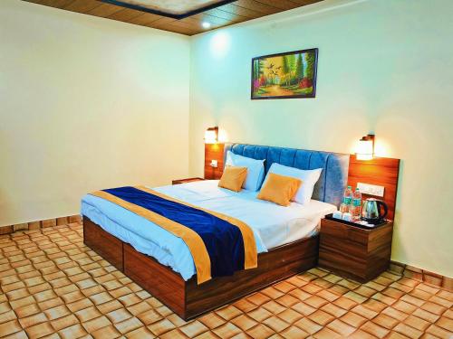 a bedroom with a large bed in a room at Divyam Resort in Barkot