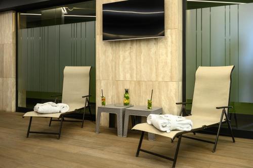a room with two chairs and a table with towels at Hilltop North Avenue by Stellar Hotels, Yerevan in Yerevan