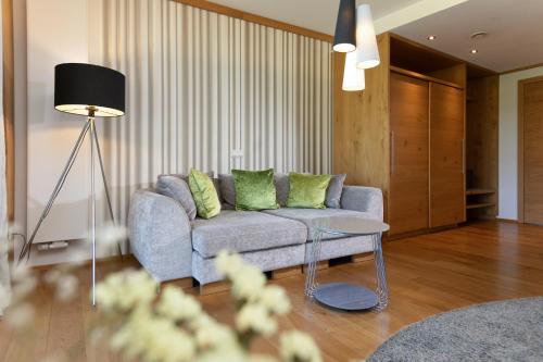 a living room with a couch and a table at Wellness & Naturresort Reischlhof in Wegscheid