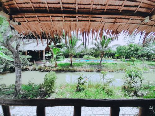a view of the garden from the porch of a resort at Green Village Mekong in Can Tho