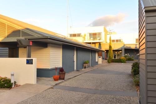 a building with a sidewalk in front of a building at Captain's at the Bay in Apollo Bay